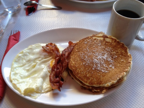 Eggs, bacon, caramel pistachio pancakes, and a bottomless cup of coffee, American-style